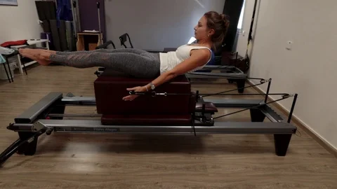 Pilates workout on a reformer Stock Footage 120341487