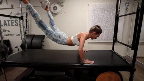 Pilates workout using a cadillac reformer Stock Footage 120339737