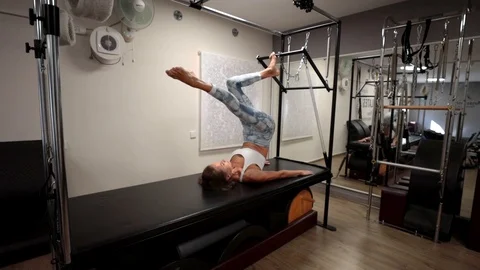 Pilates workout using a cadillac reformer Stock Footage 120345610