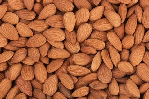 Pile of almonds close-up as background. Stock Photos