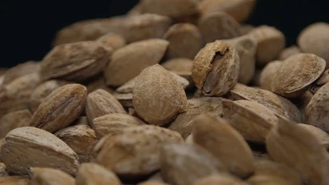 Pile of almonds in shell on a wooden table isolated on black 스톡 동영상 71087388