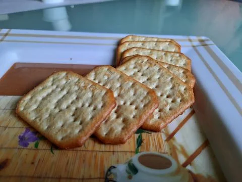 Pile and heap of a rectangle shape Salt Biscuit in a serving plate Stock Photos