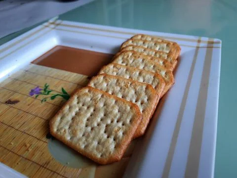 Pile and heap of a rectangle shape Salt Biscuit in a serving plate Stock Photos