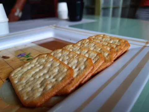 Pile and heap of a rectangle shape Salt Biscuit in a serving plate Stock Photos