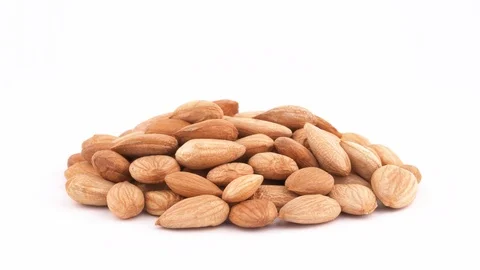 A pile of apricot kernels heap. Smoothly rotating on the turntable, isolated Stock Footage 96035320