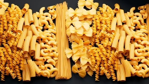 Pile of arranged raw different kinds of pasta. Seamlessly looping animation. Vídeos de archivo 126289596
