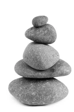 Pile of balanced rocks on plain background Stock Photos