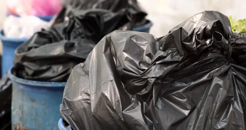 Pile of black garbage bags plastic at a bin, Garbage pile, Plastic waste Video stock 334576227
