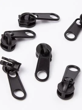 Pile of black zipper pull sliders Stock Photos