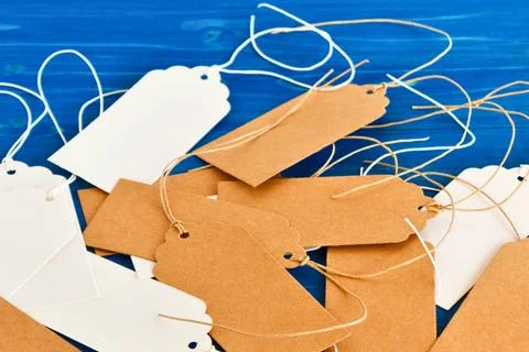 Pile of blank gift tags with string on blue background Stock Photos