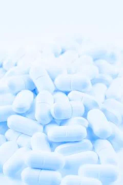 Pile of blue tablets closeup Stock Photos
