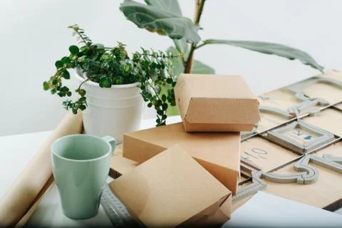 Pile of boxes and tools, workplace of a very busy box maker Stock Photos
