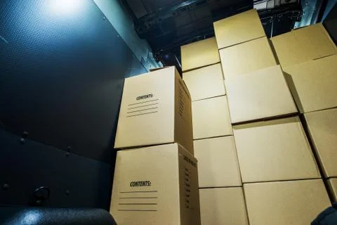 Pile of boxes in a cargo van closeup. products transportation industry. shipp Stock Photos
