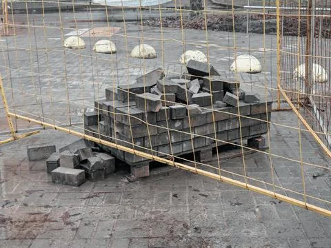 Pile of Bricks at Construction Site Behind Fence 스톡 사진
