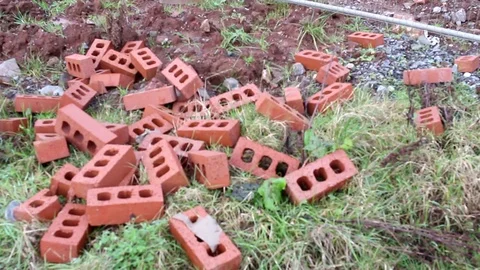 A pile of bricks on the ground and grass. Video stock 85202576