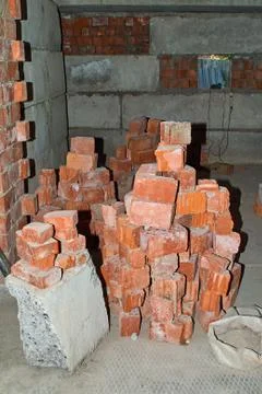 Pile of Bricks by an Old Brick Wall taken by an old building in St. Petersburg Foto stock