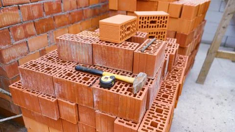 A pile of bricks with tools on it at the construction site Foto stock
