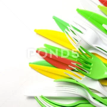 Pile of bright yellow, green and white plastic kitchenware single use applian Stock Photos
