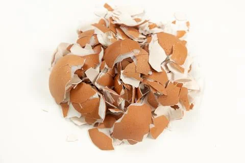 Pile of broken brown eggshell isolated on white background. Fotos Stock