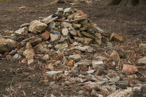 Pile of broken red bricks and fragments of concrete from destroyed building Stock Photos
