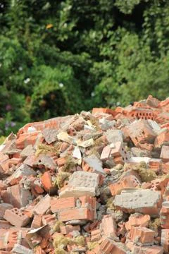 Pile of broken red bricks on construction site Foto stock