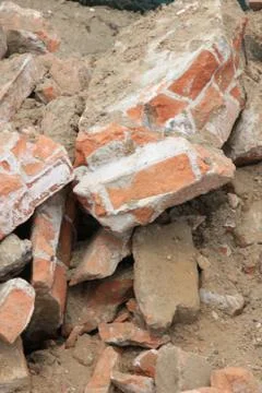 Pile of broken red bricks on construction site Stock Photos