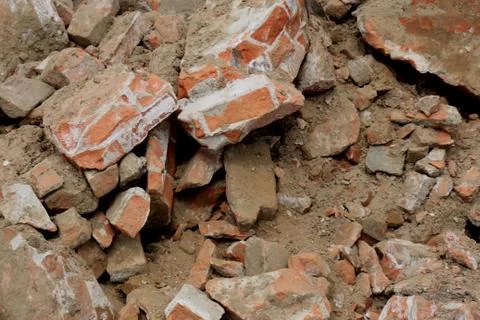 Pile of broken red bricks on construction site Foto stock