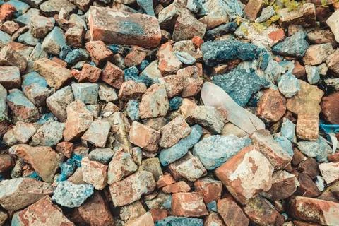 Pile of broken red bricks with garbage. Stock-Fotos