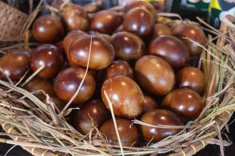A pile of brown chicken eggs on a haystack Stock Photos