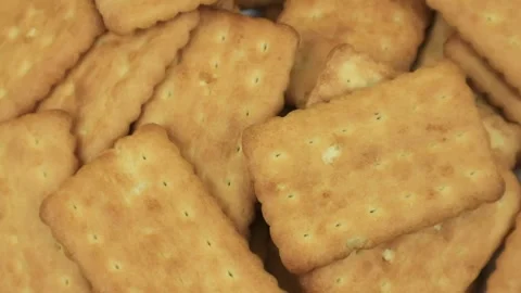 Pile of brown rectangular butter biscuits on rotary display Stock Footage 289000857