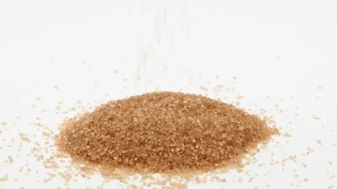 Pile of brown sugar and falling sugar on white background Stock Footage 145282212