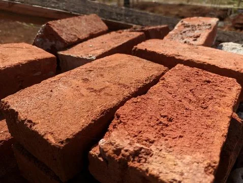A pile of building materials, a stack of red bricks for construction Stock Photos