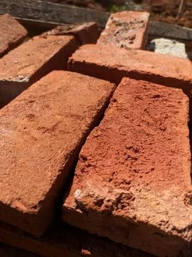 A pile of building materials, a stack of red bricks for construction Stock Photos