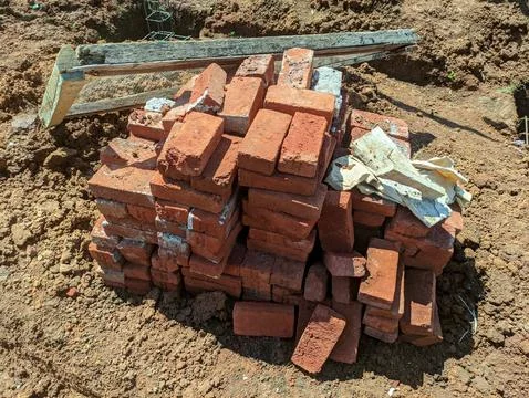 A pile of building materials, a stack of red bricks for construction Stock Photos