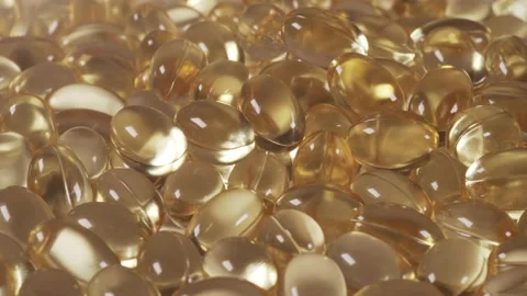 Pile of Capsules Omega 3 and D-3 background, close up, nutritional supplements Stock Footage 136123790