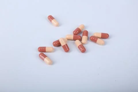 A pile of capsules on a white background Stock Photos