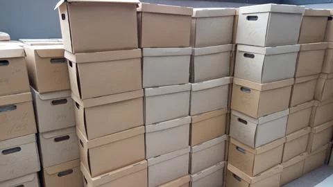 Pile of cardboard boxes on the ground. Stack of carton boxes for office docum Stock Photos