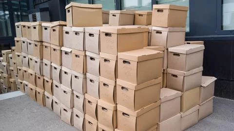 Pile of cardboard boxes on the ground. Stack of carton boxes for office docum Stock Photos