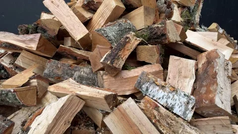 Pile of chopped and split firewood with bark, stacked wood logs for heating Video stock 346516233