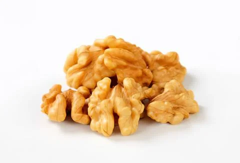 Pile of chopped walnuts on clean surface Stock Photos