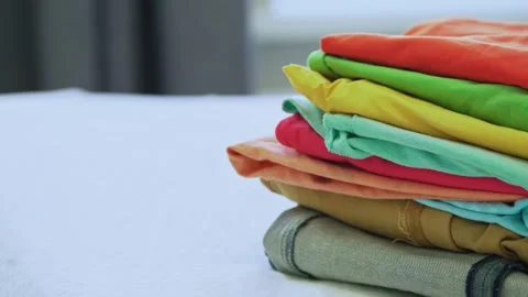 Pile of Clothes on Bed During Home Organization Routine 動画素材 340504316