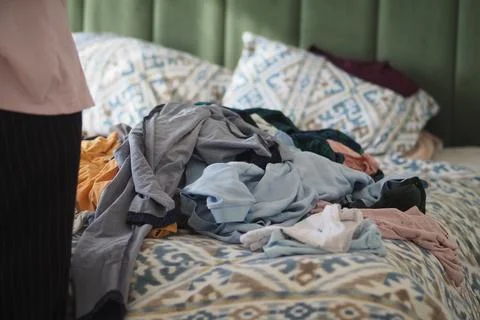 Pile of clothes on a bed during a weekend afternoon 스톡 사진