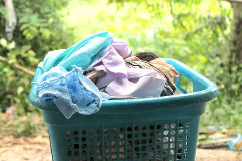 Pile of clothes overflow plastic laundry basket for washing Stock Photos