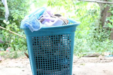 Pile of clothes overflow plastic laundry basket for washing Stock Photos