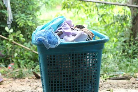 Pile of clothes overflow plastic laundry basket for washing Stock Photos