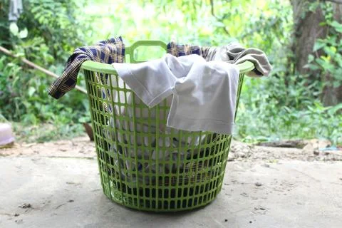 Pile of clothes overflow plastic laundry basket for washing Stock Photos