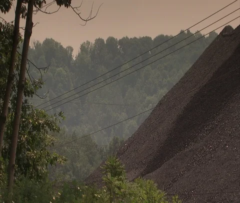 Pile of coal and trees surrounding Century Mine. Stock Footage 86695787
