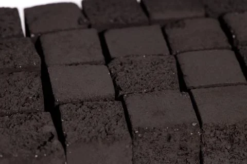 A pile of coal for a hookah in the shape of a square Stockfoto's