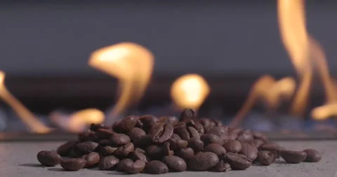 A pile of coffee beans with a fire in the background Stock Footage 276662125