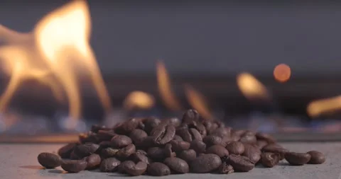 A pile of coffee beans with a fire behind them Stock Footage 276662123